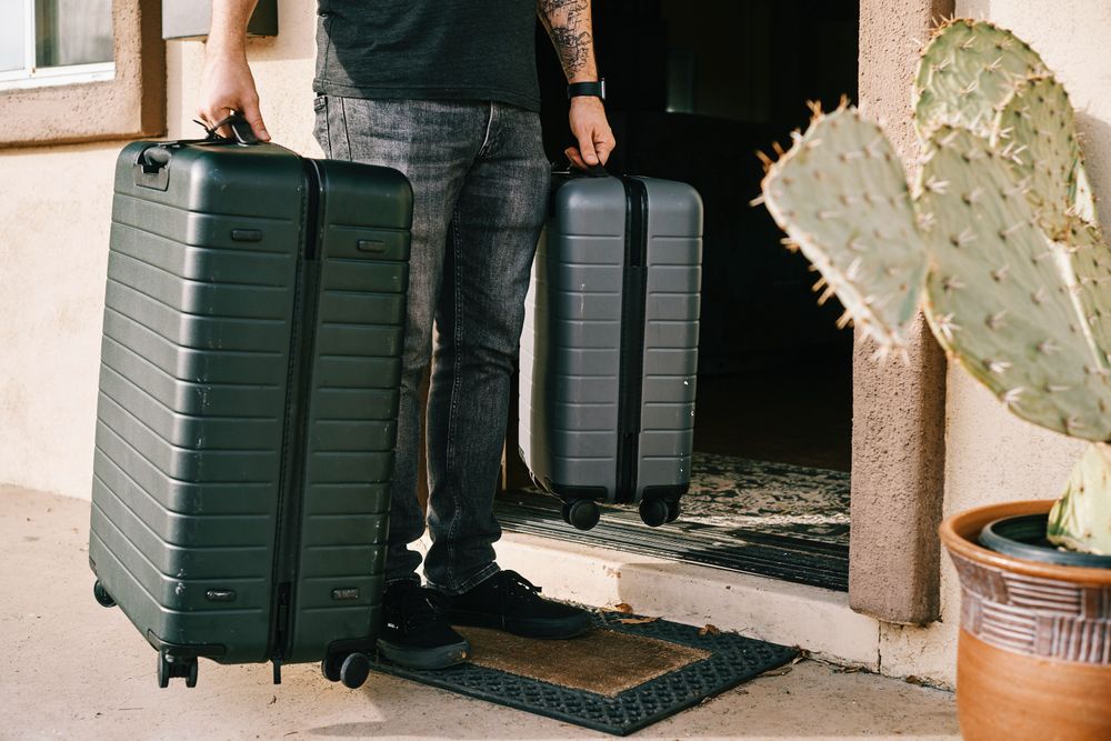 Person carrying to bags of luggage