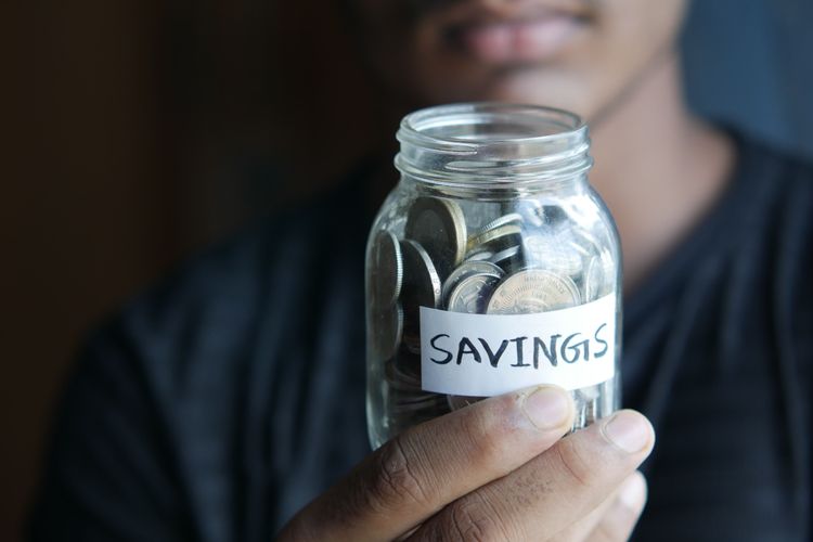 Jar of coins with savings label