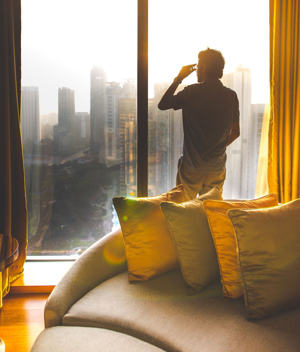 four throw pillow across man wearing grey polo shirt