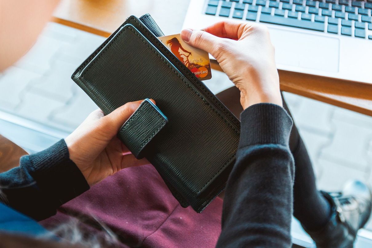 Person pulling credit card out of a wallet