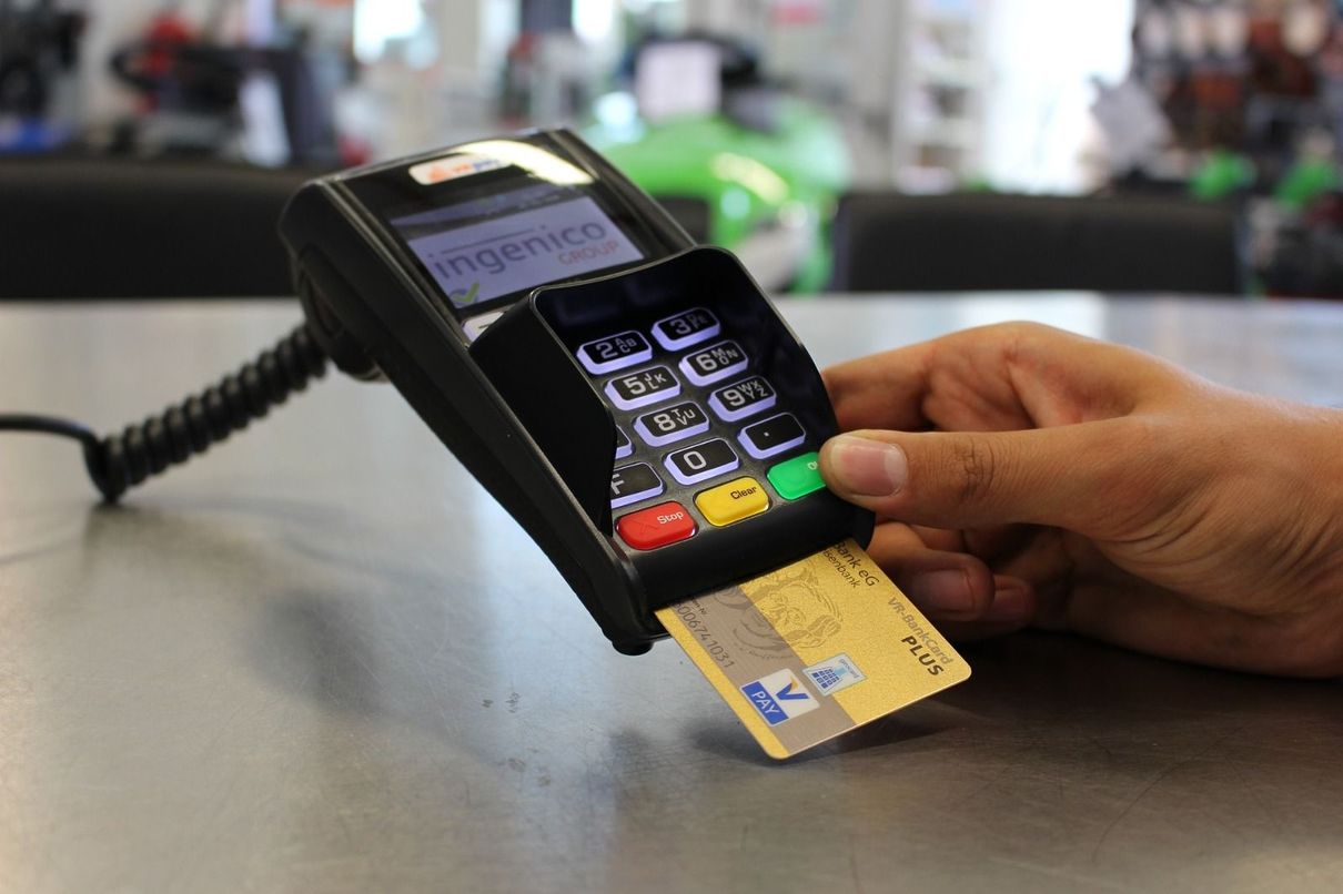 Person inserting a credit card to a terminal