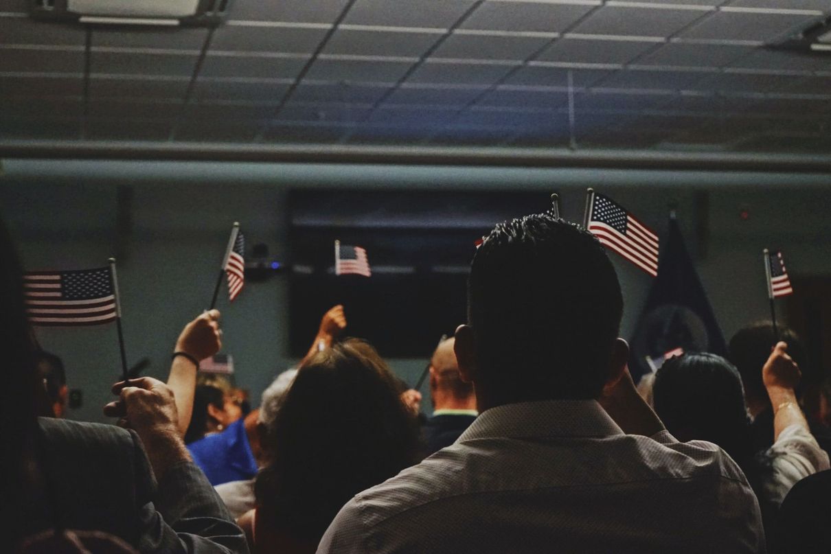 Pictures of people holding up the American Flag