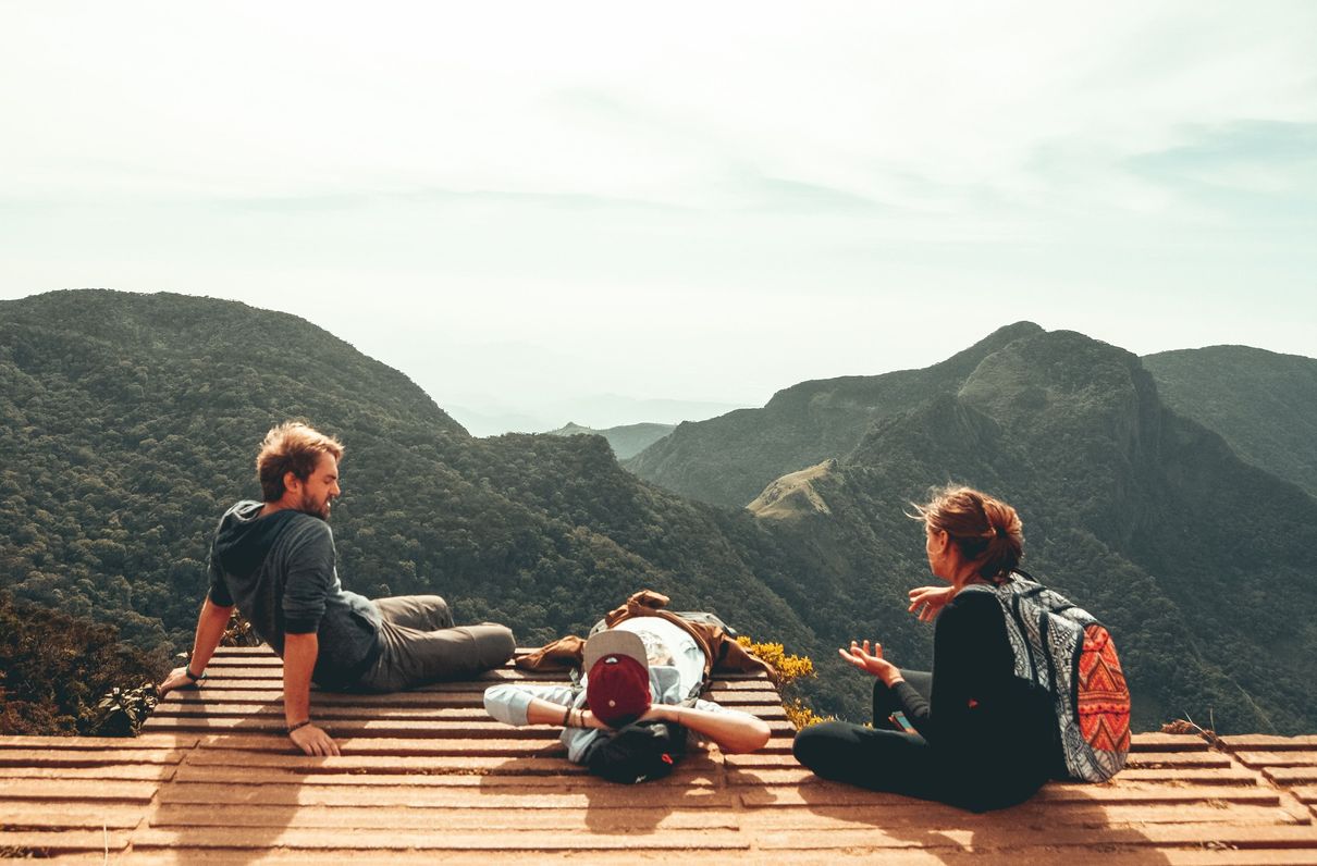 three people overlooking mountain